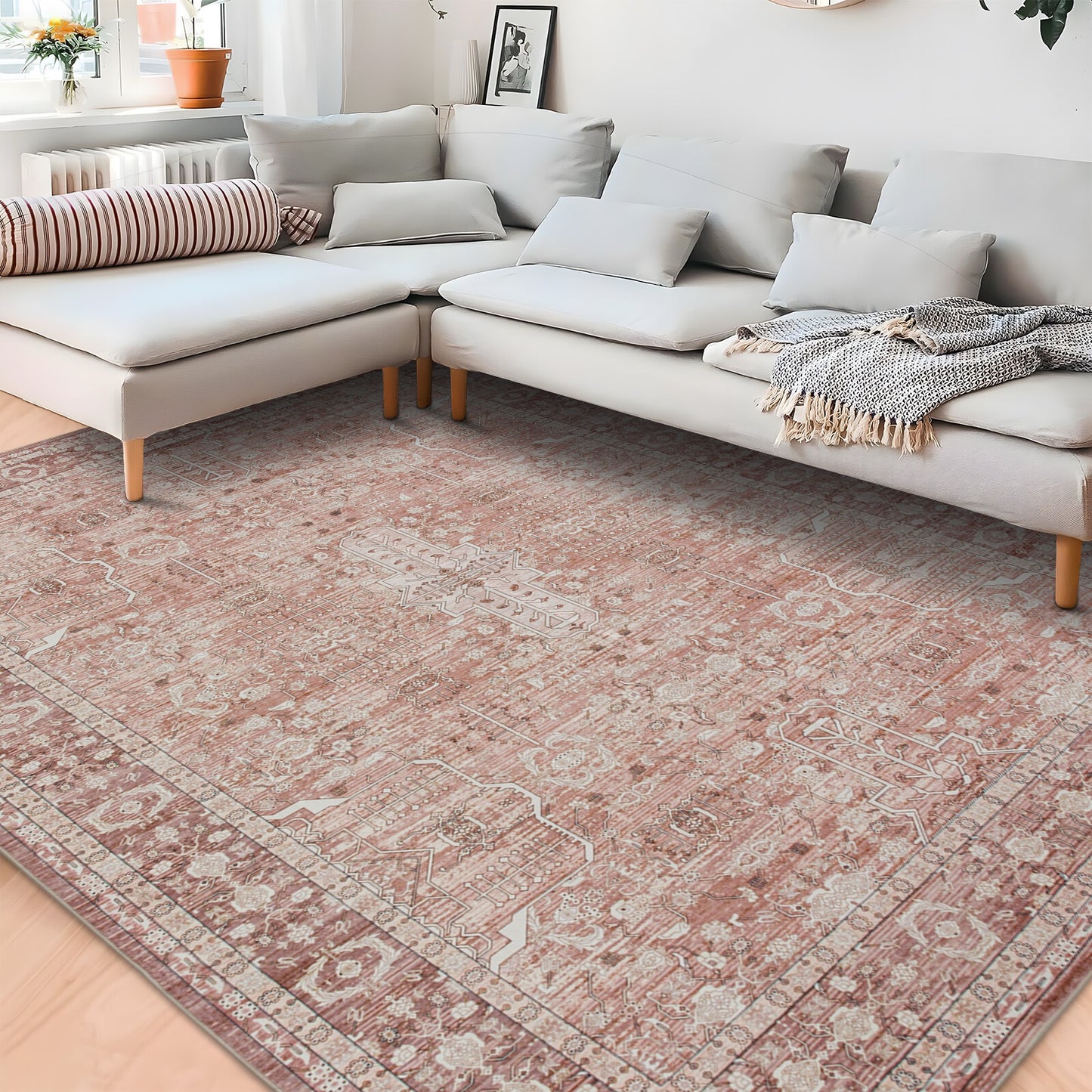 Living room with a patterned rug, sectional sofa, and decorative pillows.