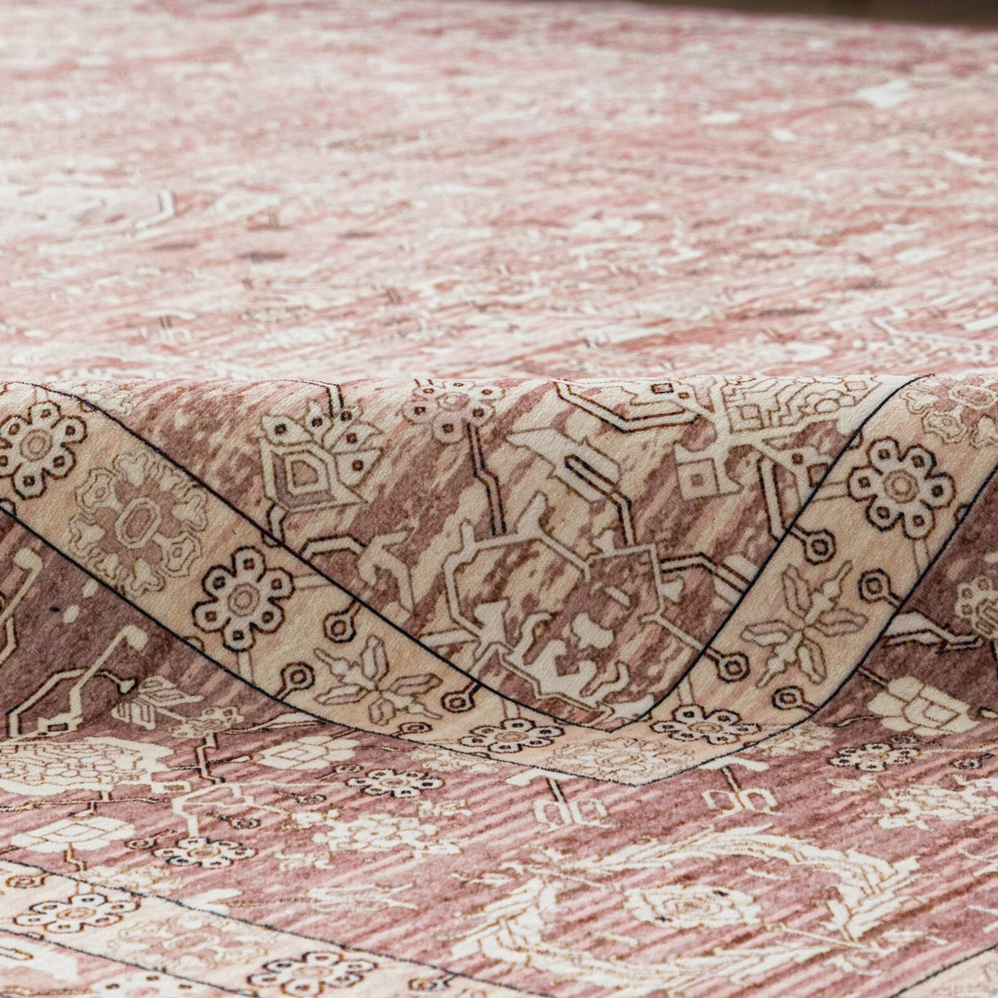 Close-up of a patterned rug with intricate designs on a textured surface.