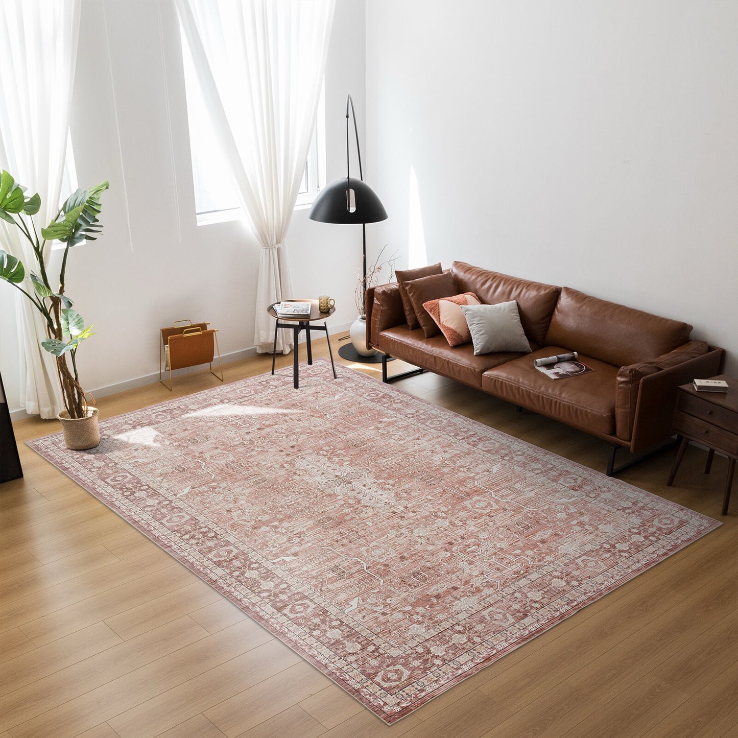 Living room with a brown leather sofa and patterned rug.