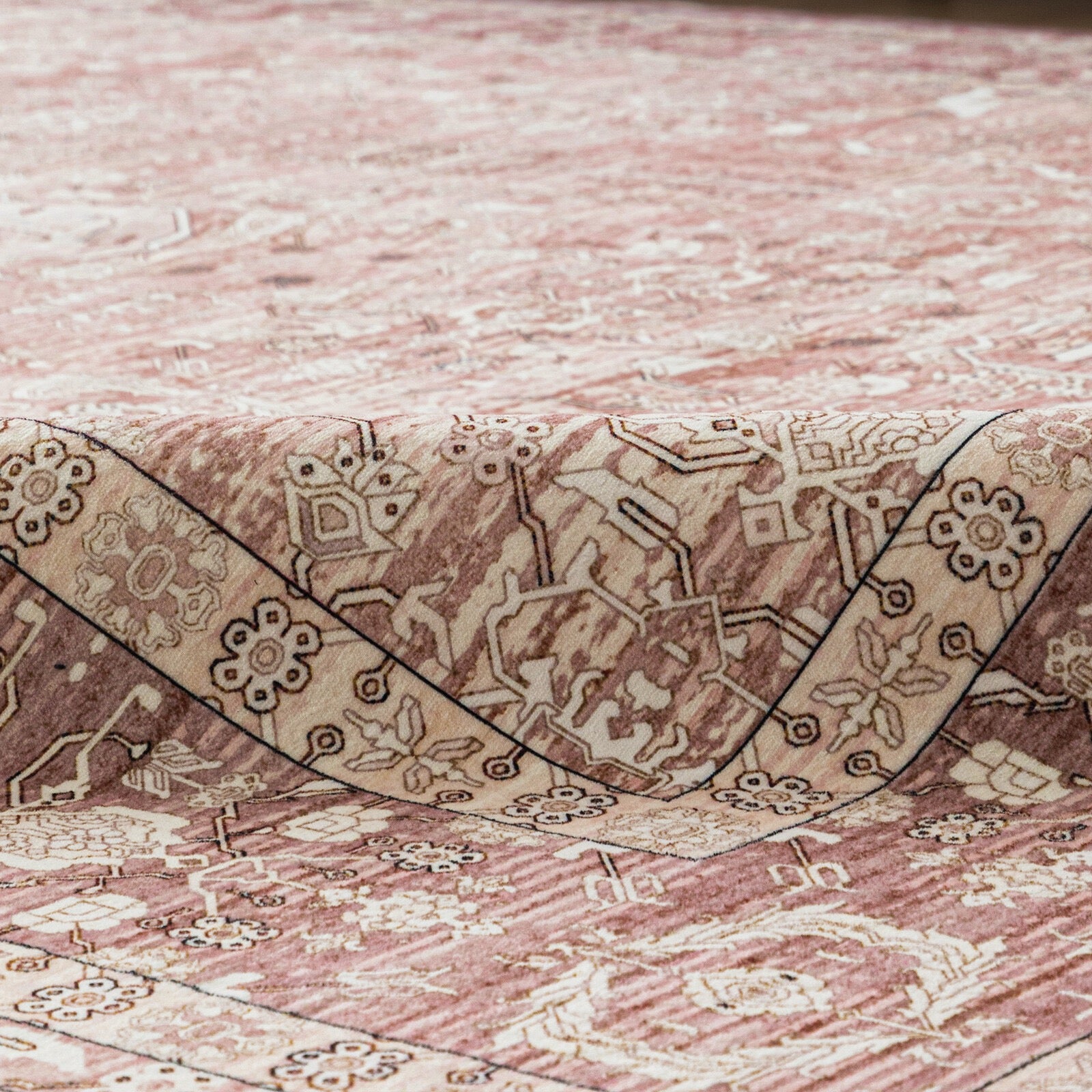Close-up of a patterned rug with intricate designs on a textured surface.