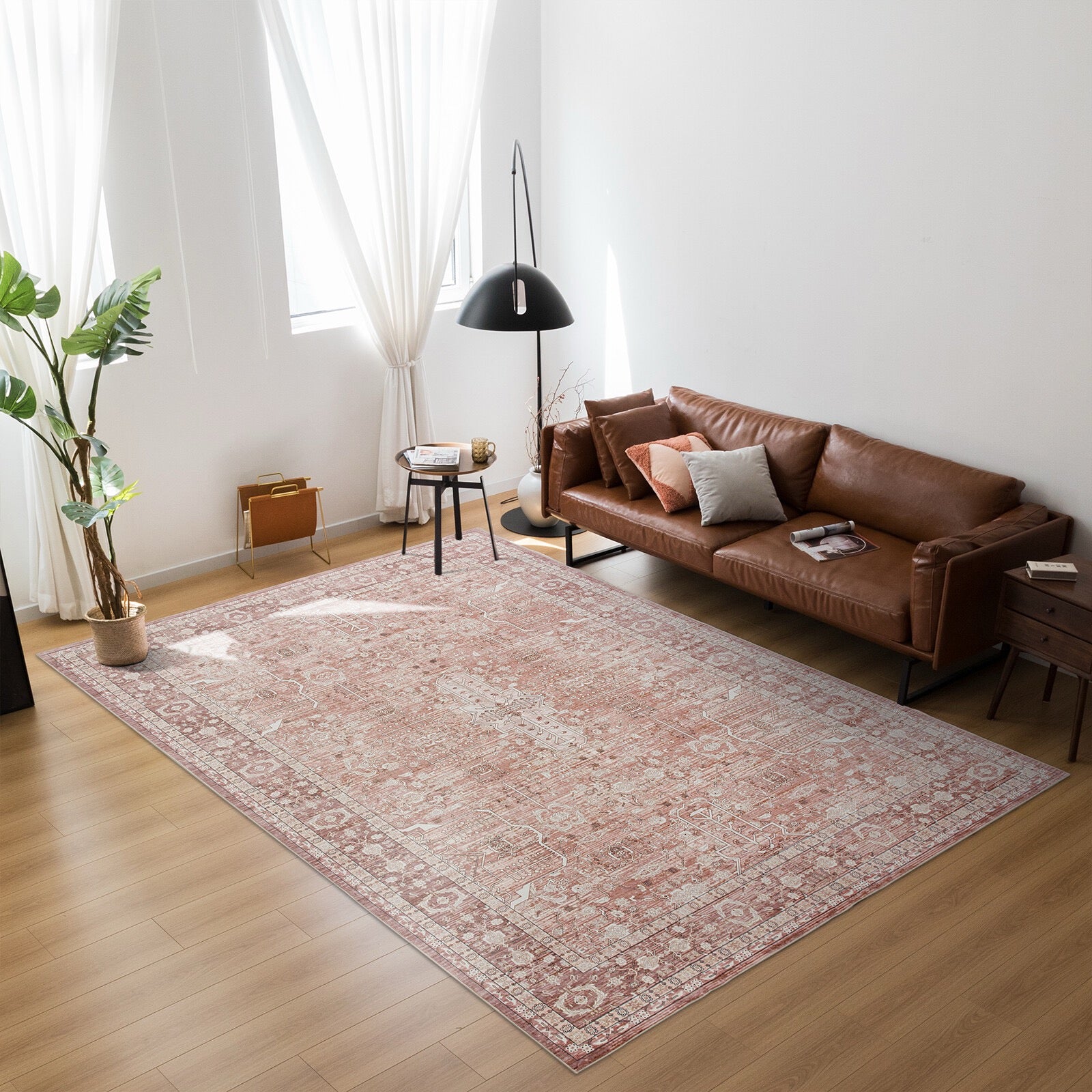 Living room with a brown leather sofa and patterned rug.